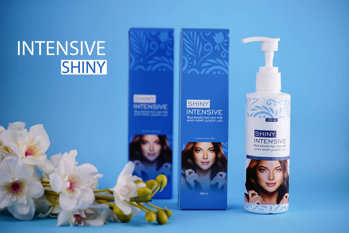 Woman applying thickening tonic to roots of fine hair with dropper applicator